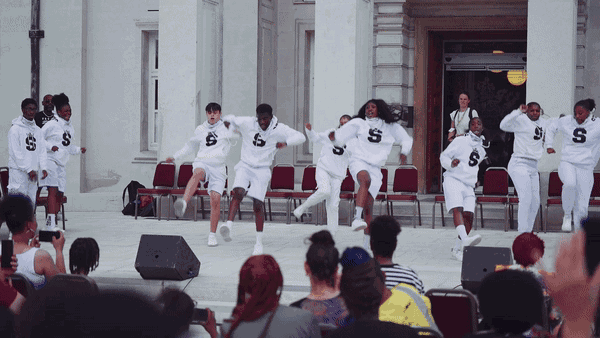 A group of young people perform a dance in front of Waltham Forest Town Hall