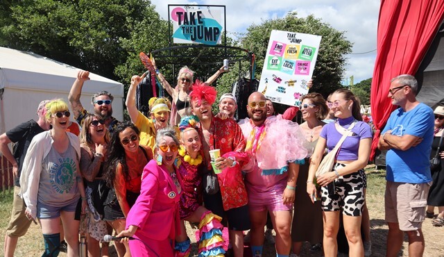 A group of performers from Take the Jump dressed in bright colours