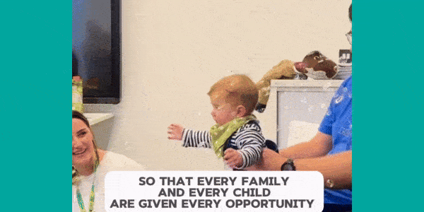 A baby bounces up and down in excitement in a man's arms as bubbles swirl around it