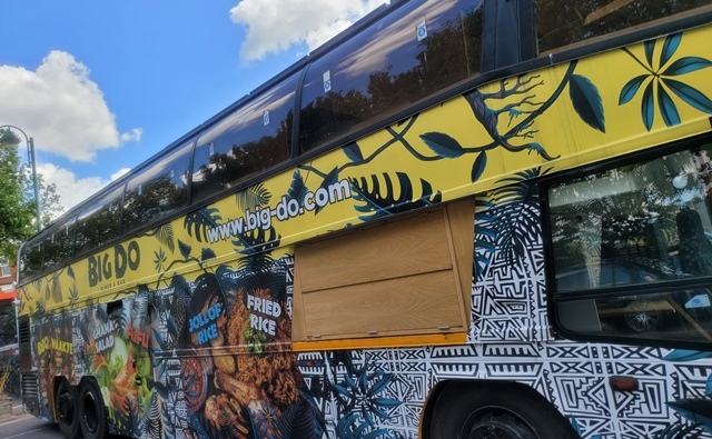 Brightly painted bus with www.big-do.com written on the side