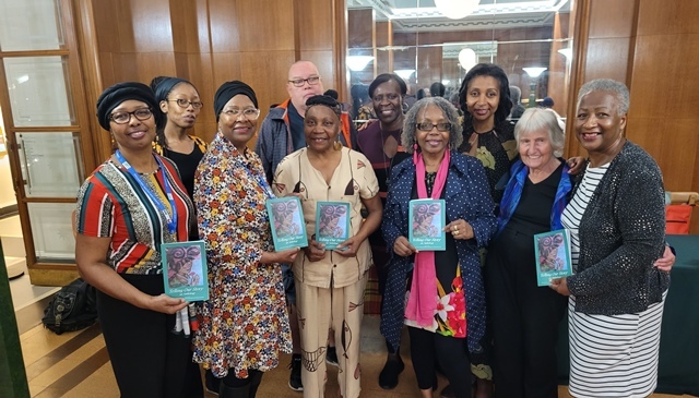 A group of people from the Waltham Forest Antigua & Barbuda and Dominica Twinning Association pose for a photo in Waltham Forest Town Hall