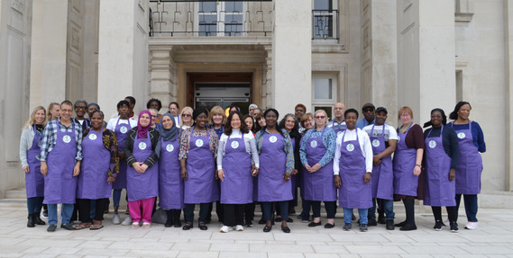 Waltham Forest's catering team pose in front of the Town Hall wearing the new allergen-friendly aprtons