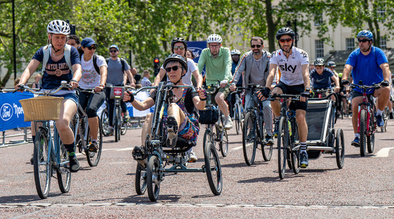 Group of cyclists with a lady on an adapted cycle at the front