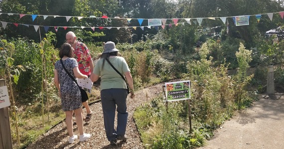 An image of people walking in the Pastures Community Garden