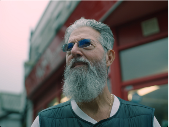 A close up of a person with a beard looking past the camera from the short film Probably not the haircut