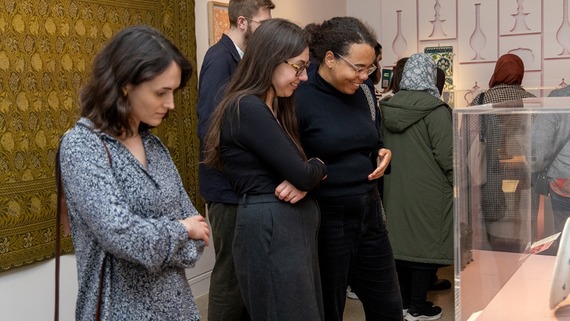 a photograph of people enjoying an exhibition at William Morris Gallery