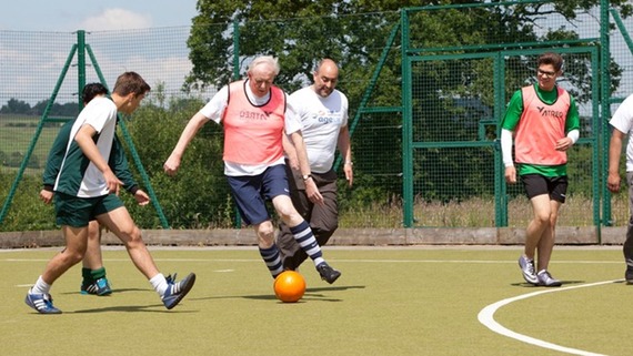 a photograph of a group of men playing football