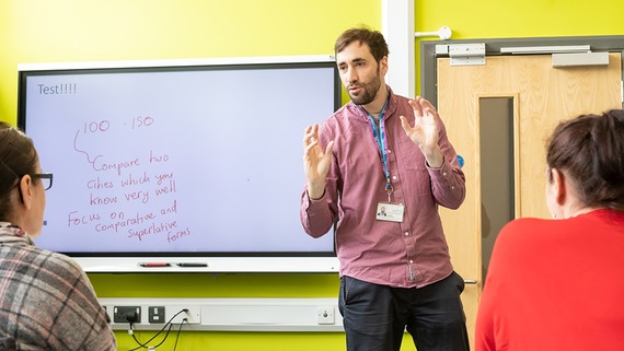 a photo of a man hosting or teaching a class