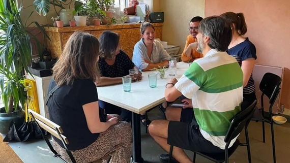 A photo of a grou of people sitting around a table