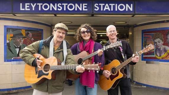 a photograph of three buskers posing outside leytonstone station
