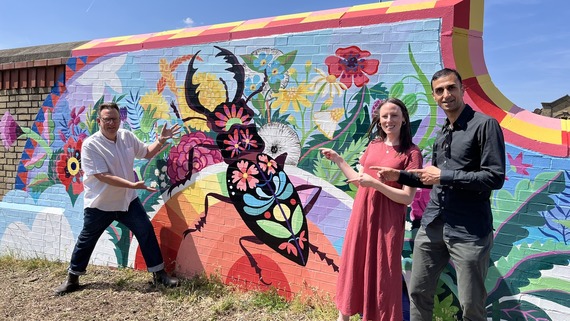 A photo (L2R)of Cllrs Loakes, Dore and Khan unveiling Leytonstone's stag beetle mural