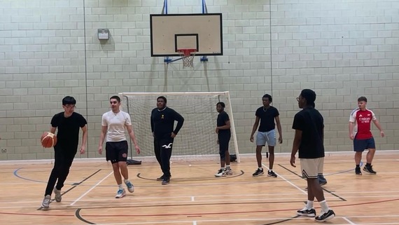 a photo of some young chaps playing basketball