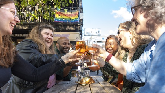 A photo of  group of drinkers cheersing
