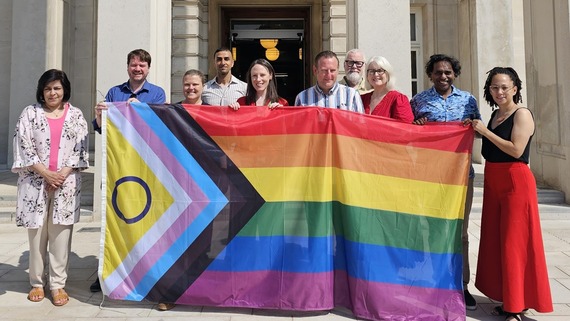 A photo of Waltham Forest Council cabinet posing with the LBGBTQ+ flag