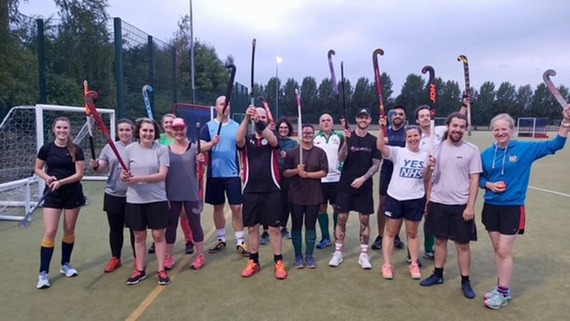 A photo of the Waltham Forest Hockey Club posing together and smiling