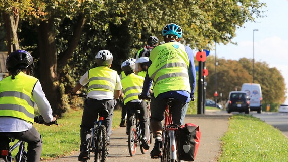 A photo of some people of different ages cycling