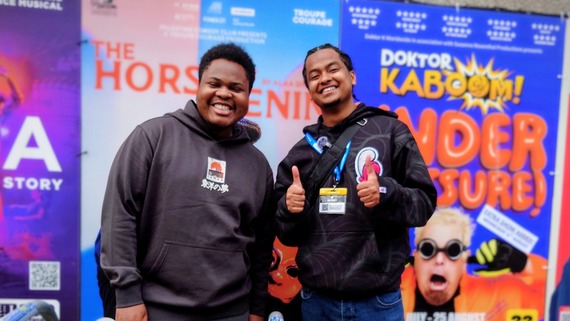 A photo of two young men giving the thumbs up and generally loving life