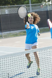 child playing tennis