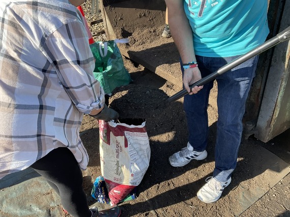 people collecting soil conditioner