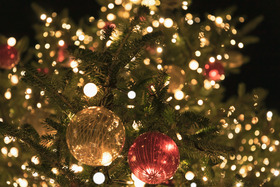 Close up image of a Christmas tree with lights and baubles