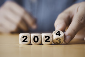 Four dice shapes which spell out 2024.