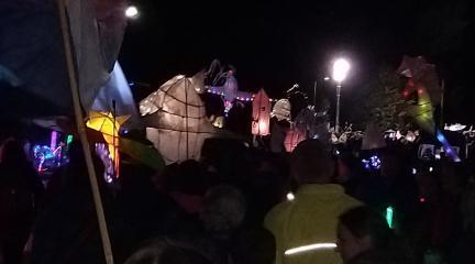 People in a procession at night holding lanterns