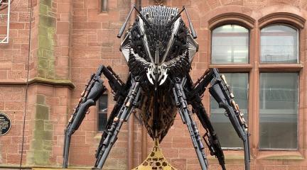 A bee sculpture made out of guns and knives on display outside Barrow Town Hall