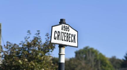 Black and white A595 Grizebeck road sign