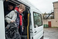 Student getting off minibus