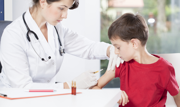 Doctor helping child have immunisation