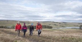 A group of people walking on a fell.