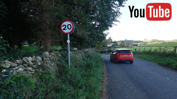 A car driving past a 20mph sign