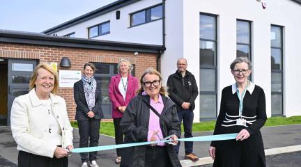 People holding a ribbon at the official opening of Channelside alternative provision