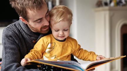 Man reading to his son