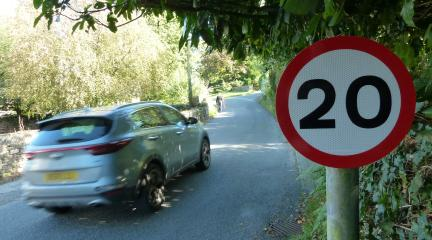 A car driving past a 20mph sign