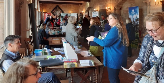 People in a hall at a leaflet swap.