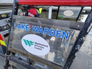 Lake Warden sign on a boat