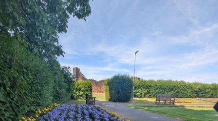 Flowers in Penrith Castle Park with the castle ruins in the background