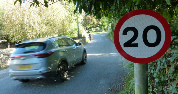 A car driving past a 20mph sign