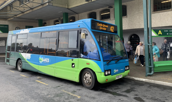 A bus waiting at a bus stop at Kendal bus station