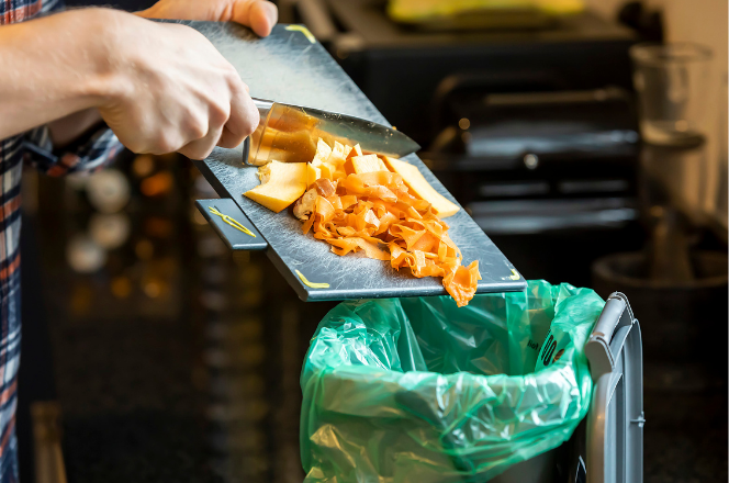 Food being scraped into recycle bin