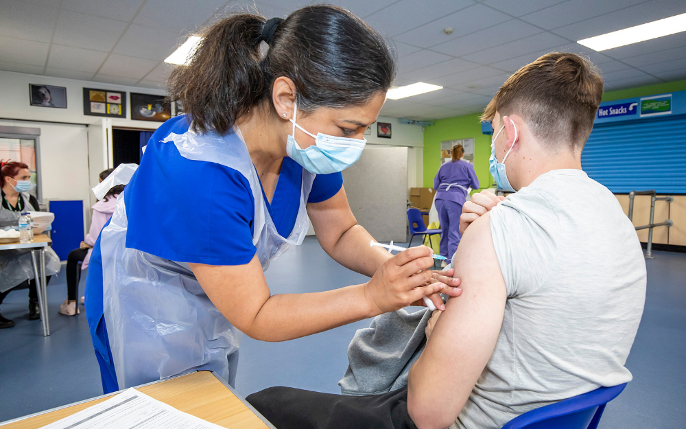 Someone getting a covid-19 vaccine at our 16+ vaccine pop up