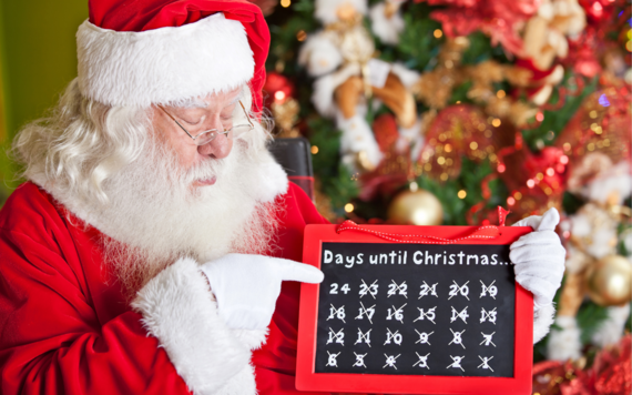Father Christmas in front of a Christmas tree pointing to a calendar with all dates except 24 crossed out