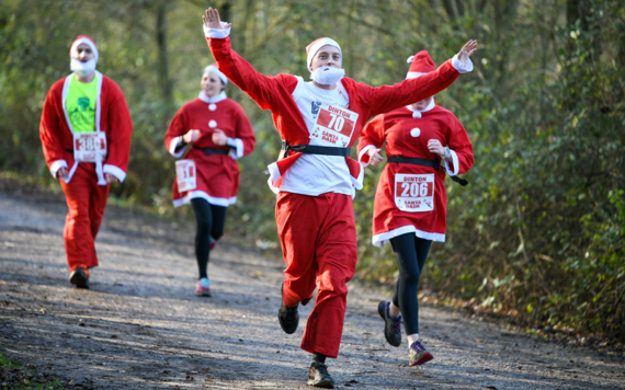 image of a man running in a santa costume