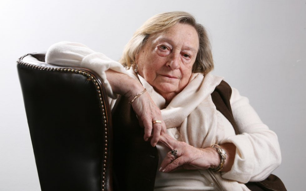 Iby Knill rests her arm on an armchair, she is a survivor of the Holocaust