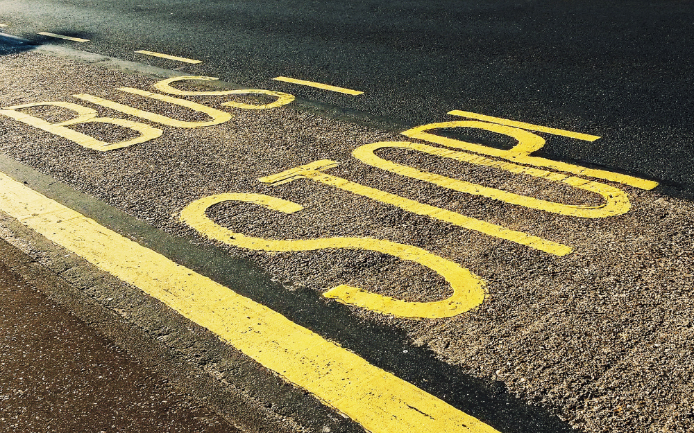 Text reading 'bus stop' written onto a road where a bus stop is