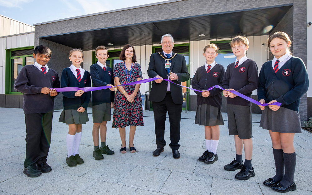 Schoolchildren and the headteacher at Farley Hill primary open their new school