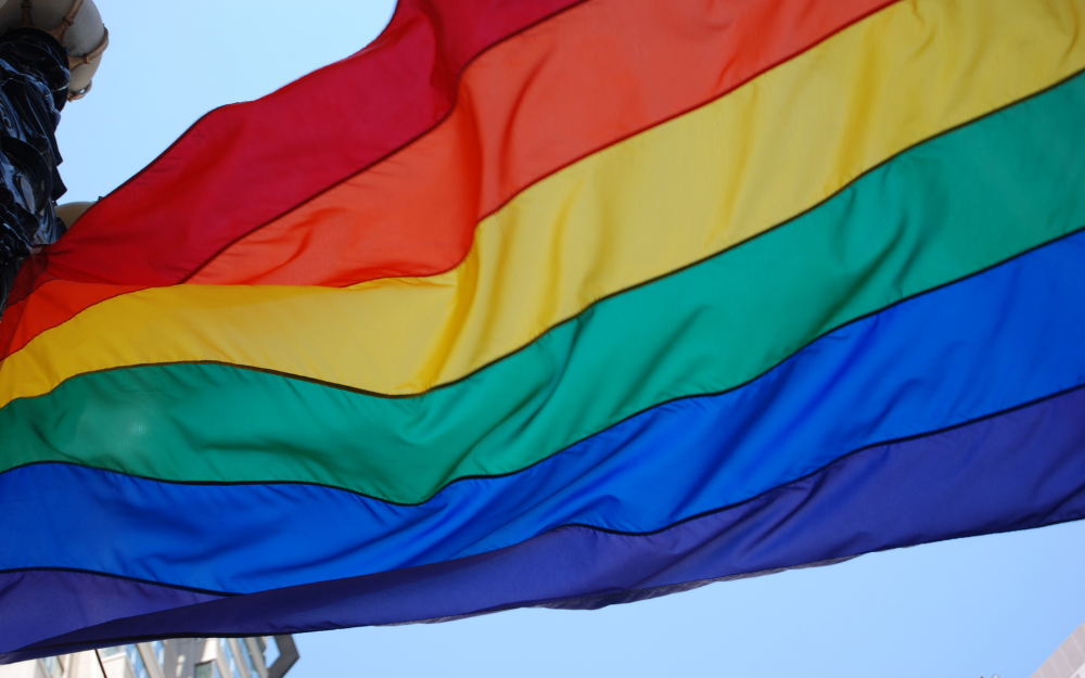 Image of the pride flag flying in the wind 