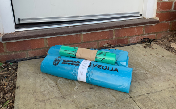 Image of blue bag roll and food caddy liners on doorstep