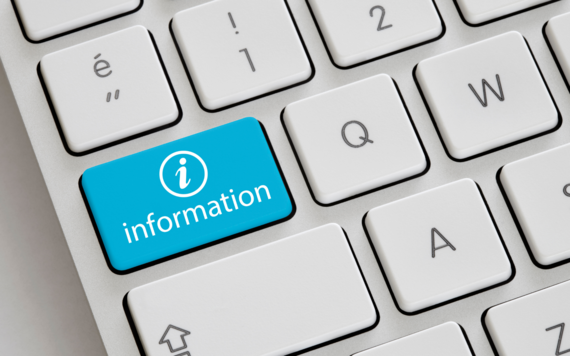 Computer keyboard with close up of a button that says information